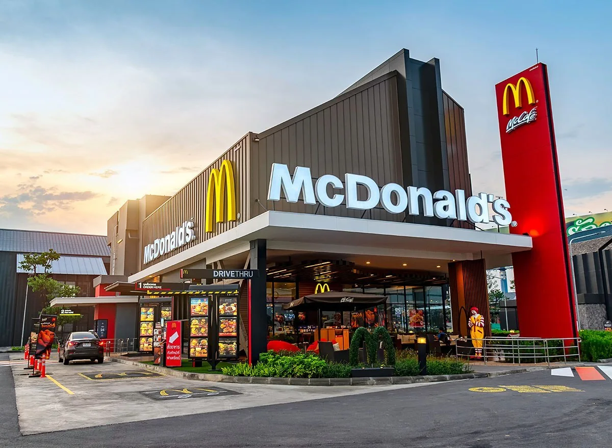 McDonald’s restaurant exterior at dusk with illuminated golden arches